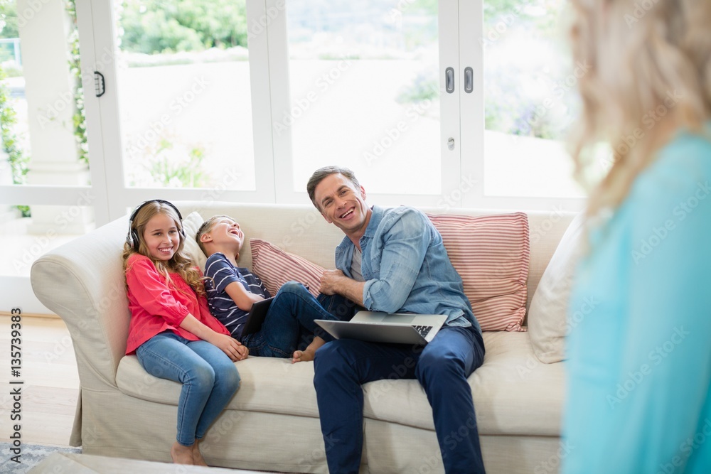 Father and kids having fun in living room