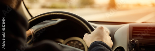 Slika na platnu Driving car hands on steering wheel