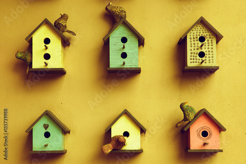 many small bright bird houses, spring background