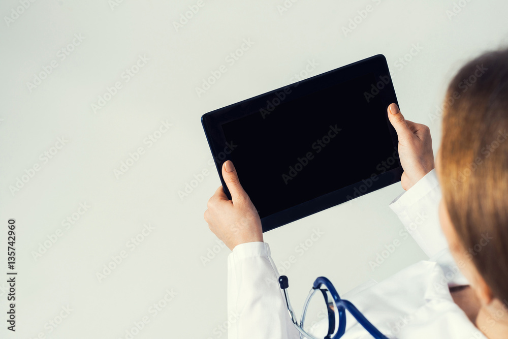 Close of female doctor hands working with tablet pc computer