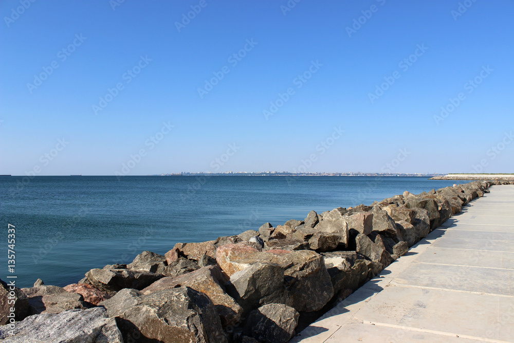 granite stones to protect the shore from the surf of the sea waves granite stones to protect the shore from the surf of the sea waves