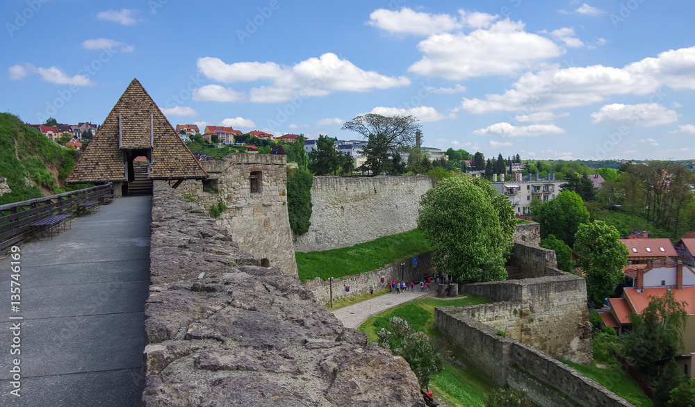 Walls and main gate of rampart of the Eger fort (castle) with medieval town of Eger at background . Hungary