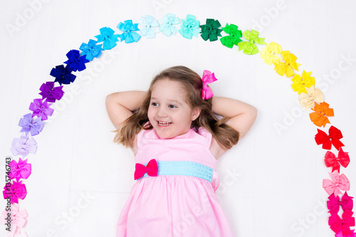 Little girl with colorful bow. Hair accessory
