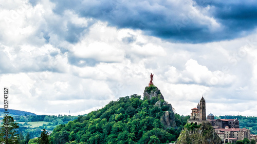 Two holy rocks: Corneille rock (Mont Anis ) with red statue of Holy Mary and Aiguilhe rock with saint michel chapel, Le Puy en Velay, France photo