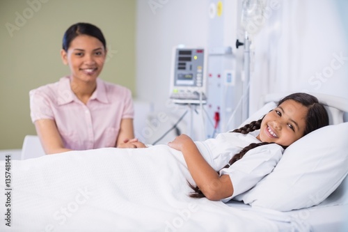 Portrait of nurse talking to a girl patient