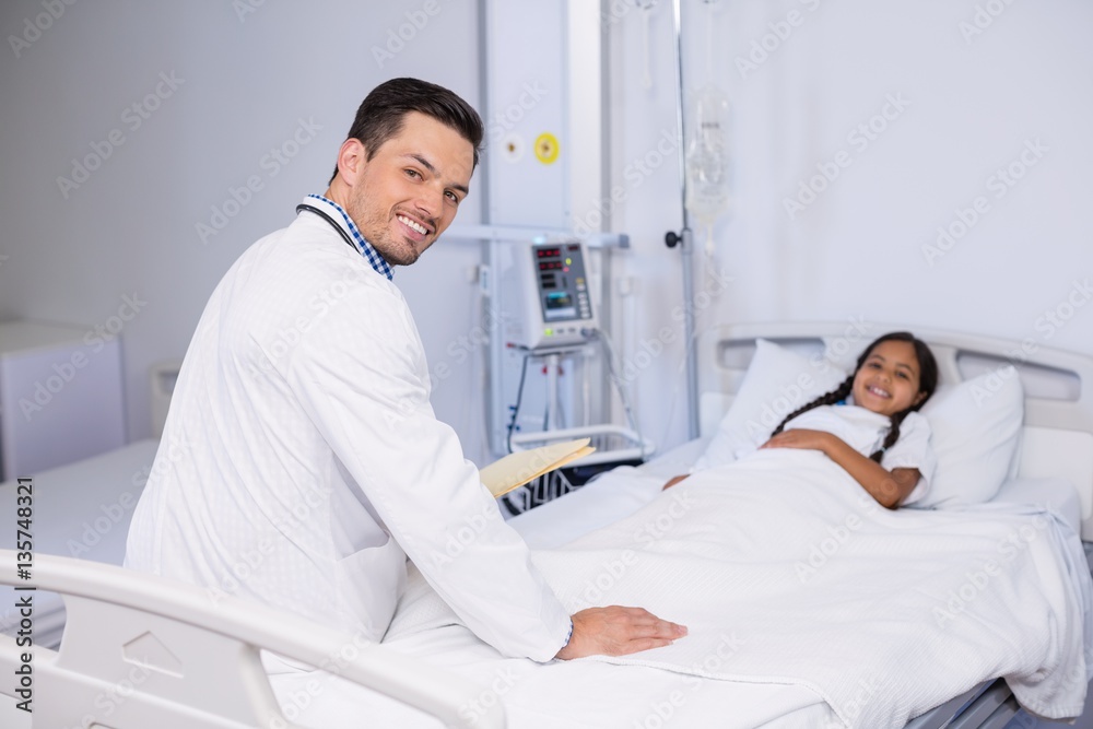 Portrait of doctor and girl patient in hospital bed Portrait of doctor and girl patient in hospital bed