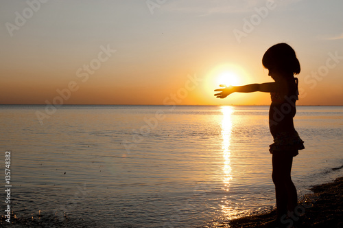 Child having fun on sunset tropical beach. Kid on summer vacation 