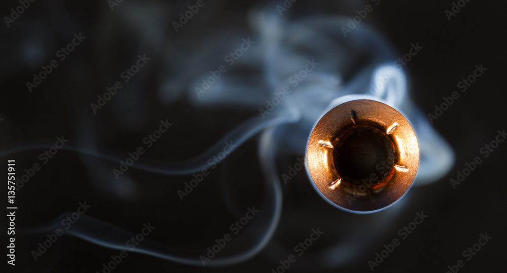 Fototapeta premium Danger close seen with a copper jacketed hollow point coming at the camera with a smoke contrail behind