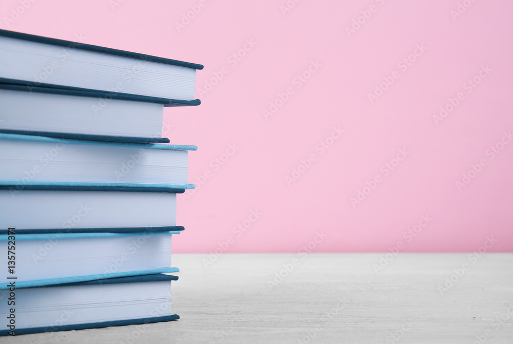 Fototapeta premium Pile of books on pink background
