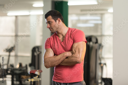 Strong Man in Pink T-shirt Background Gym