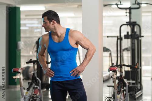 Man In Undershirt Flexing Muscles