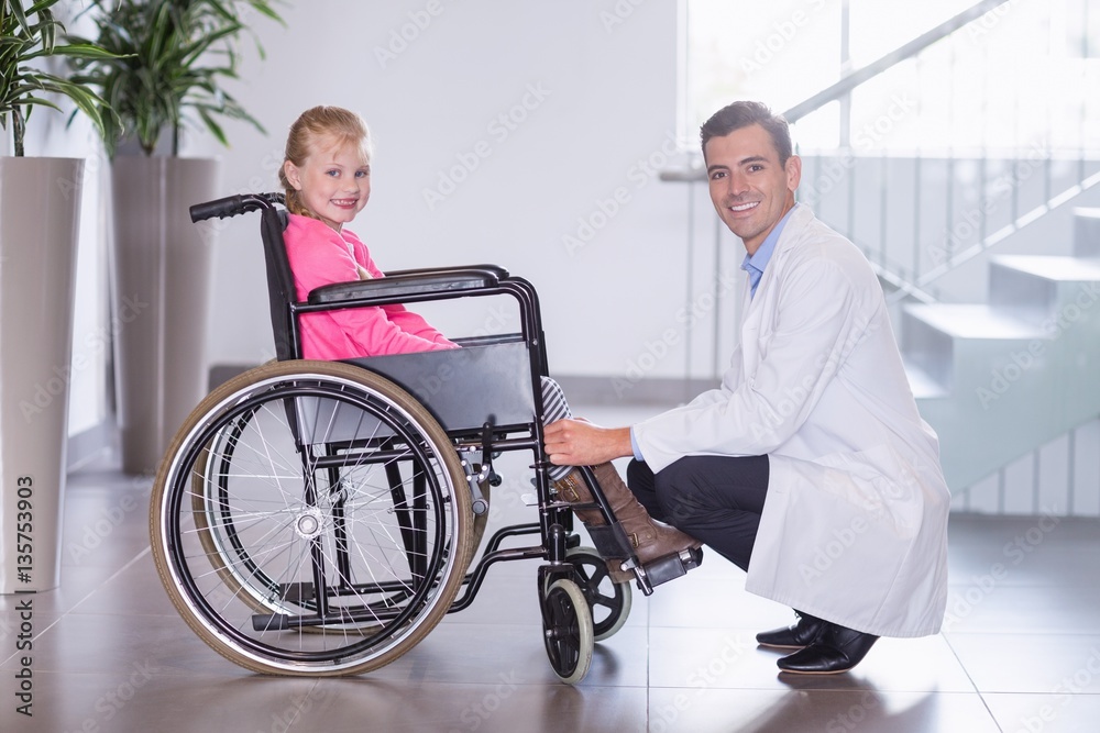 Portrait of smiling doctor and disable girl Portrait of smiling doctor and disable girl