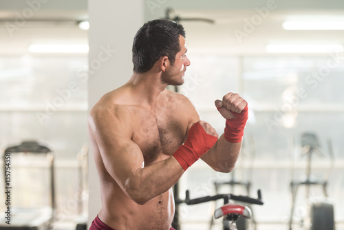 Shirtless Muscular Boxer With Gloves In Gym