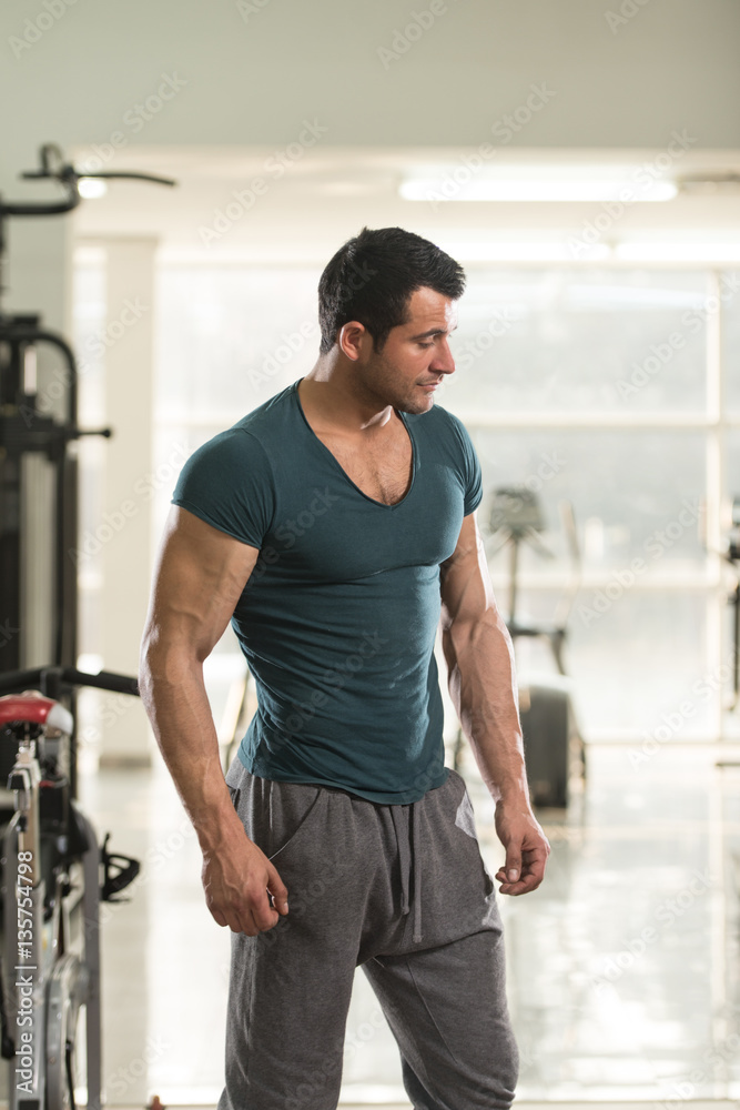 Strong Man in Green T-shirt Background Gym