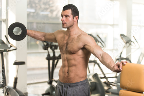 Hairy Man With Dumbbells Exercising Shoulders