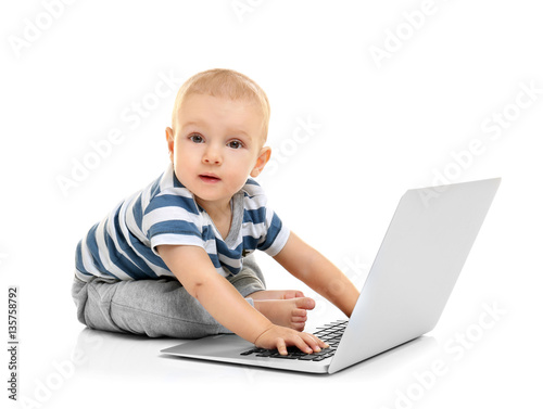 Cute baby boy with laptop o...