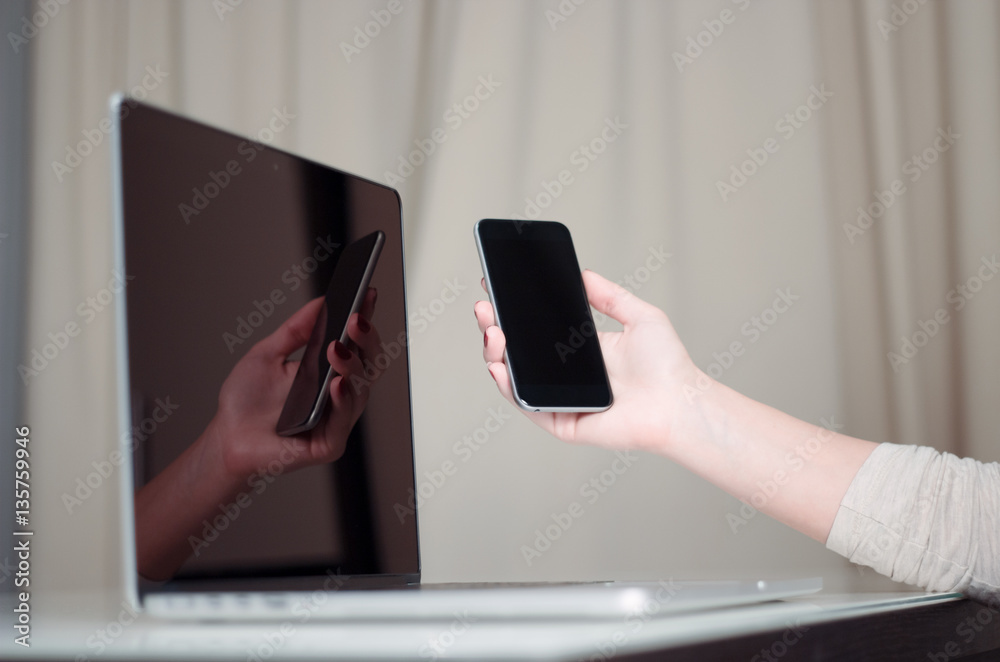 Woman is working with computer and smart phone Woman is working with computer and smart phone