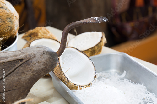 oconut grater and Coconut meat in the tray on kitchen photo