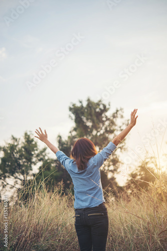 Beautiful woman hipster raising her arm in the air.