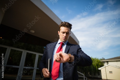 Businessman checking time on his wristwatch