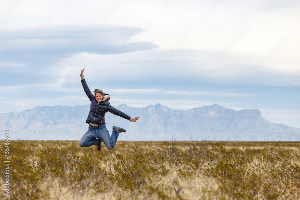 Young Woman Jumping in the Desert