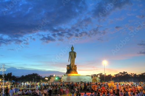 Makha Bucha Day  Unidentified thai people holding lit candle and walk around Big Buddha for Worship on the Holiday  at Phutamonthon Park Thailand.