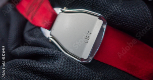 Close up of safety seat belt in the airplane .