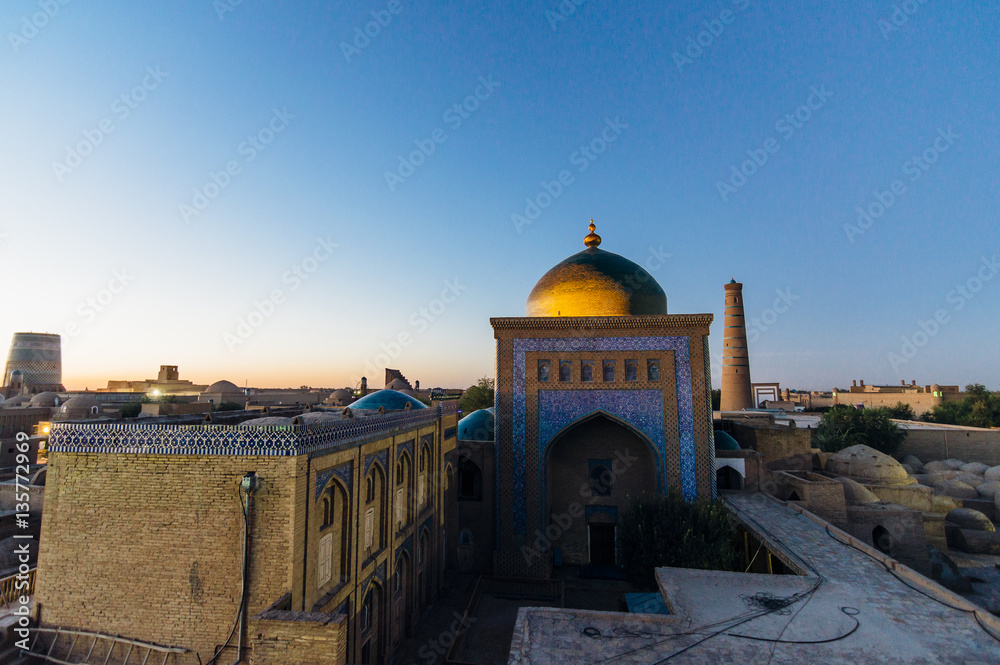  Pahlavon Mahmud Mausoleum view at the sunset time in Itchan Kala, the walled inner town of the city of Khiva, Uzbekistan. UNESCO World Heritage