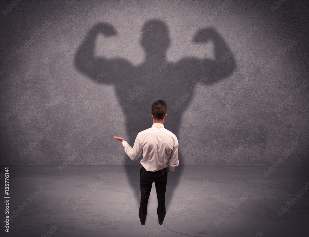 Successful businessman with strong shadow Successful businessman with strong shadow