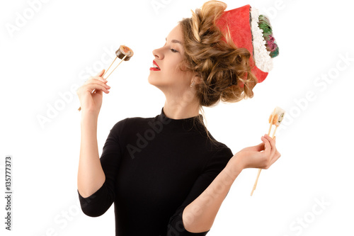 elegant woman with a fashionable hairstyle eating rolls