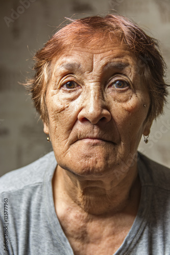 portrait of a pensive elderly woman  © shymar27