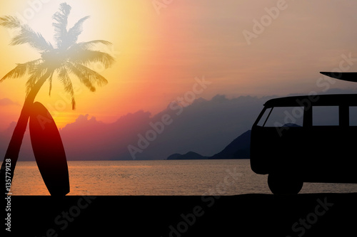 silhouette vintage car in the beach with a surfboard on the roof