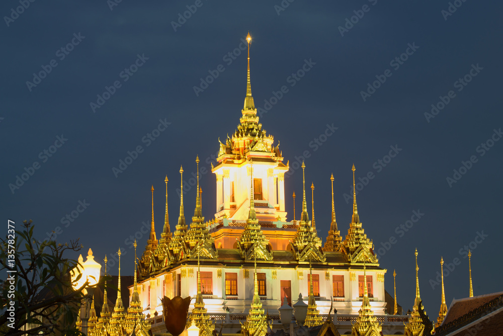 The top of the Chedi Loha Prasat buddhist temple Wat Ratchanadda against the evening sky. Bangkok, Thailand