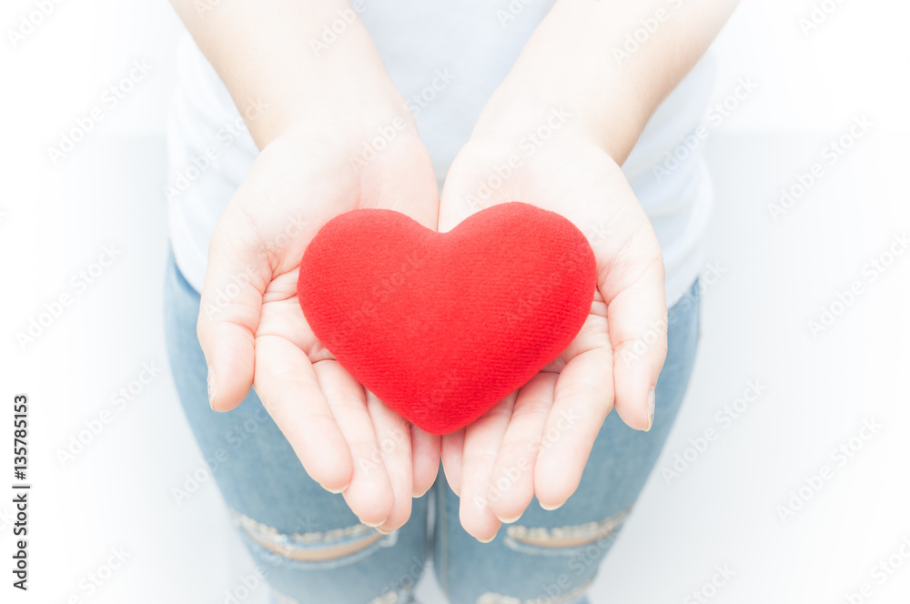 Woman holding and protecting give a red heart shape on white background close-up,Symbol of love or dating Valentines day Woman holding and protecting give a red heart shape on white background close-up,Symbol of love or dating Valentines day