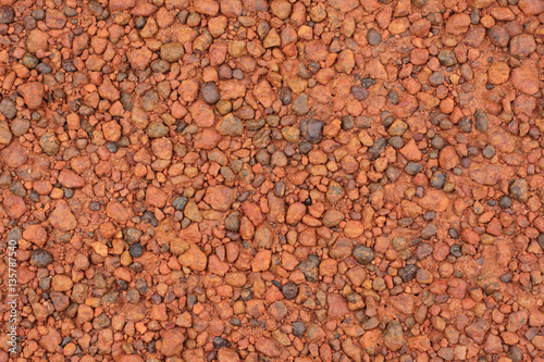 Red laterite gravel texture for background. © enrouteksm