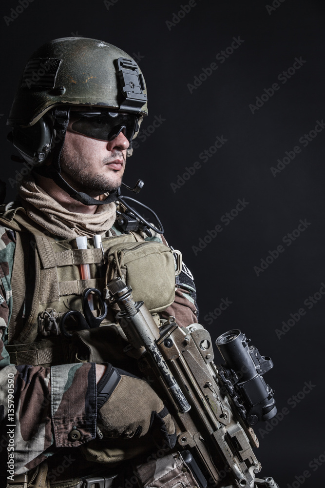 United states Marine Corps special operations command Marsoc raider with weapon. Studio shot of Marine Special Operator half-turning black background United states Marine Corps special operations command Marsoc raider with weapon. Studio shot of Marine Special Operator half-turning black background