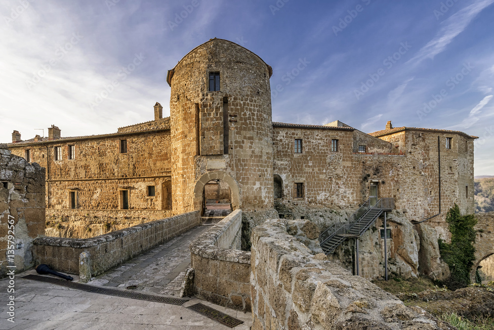 The facade of the beautiful and ancient Orsini Fortress or Rocca Aldobrandesca in the historic center of Sorano, Grosseto, Tuscany, Italy
