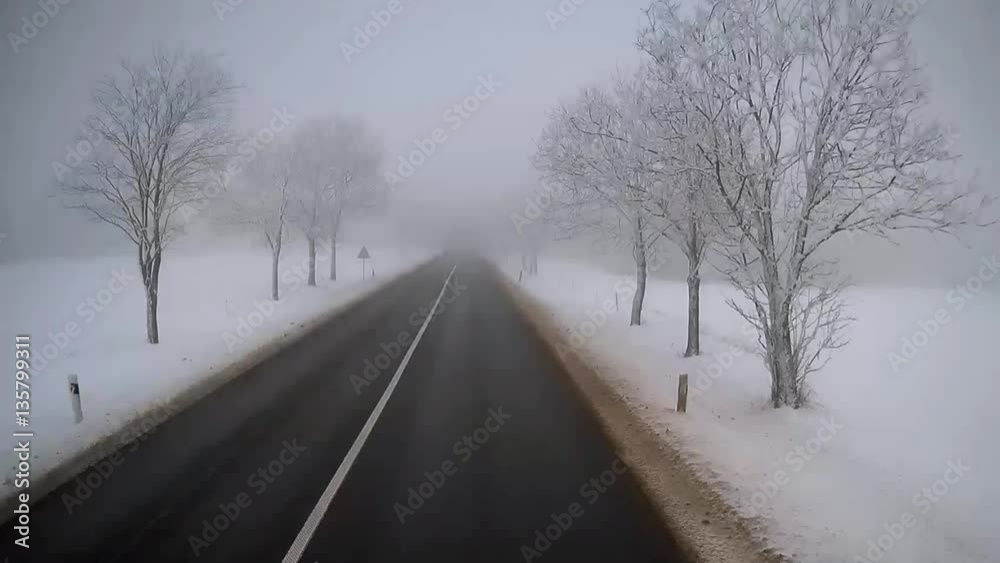 Exclusive view from the cab of a truck driver. Accelerated ride on empty road in foggy winter day Exclusive view from the cab of a truck driver. Accelerated ride on empty road in foggy winter day
