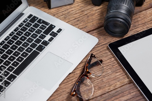 Close-up of camera, tablet, laptop, spectacle 