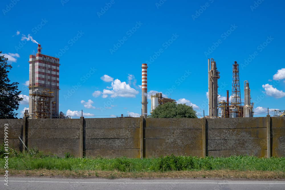 Industrial landscape with smoking chimneys over blue sky Industrial landscape with smoking chimneys over blue sky