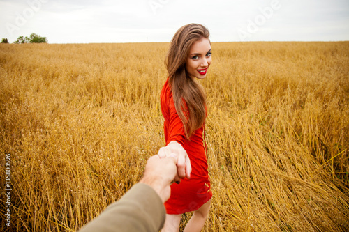 Follow me, Beautiful sexy young woman holds the hand of a man in © Andrey_Arkusha
