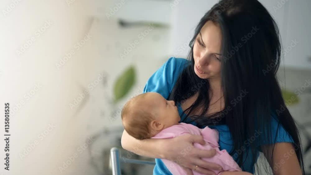 Young mother embracing her newborn baby Young mother embracing her newborn baby