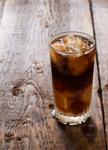 Fresh cold drink with ice on a wooden background