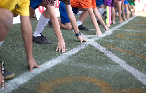 Students boy get set to leaving the starting for running competition boy at school sports day. School sports day concept.