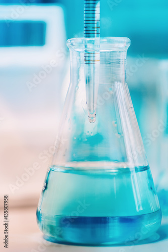 Medical details - Doctor testing probes with pipette in glass container. Close up of scientist using technology for experiments