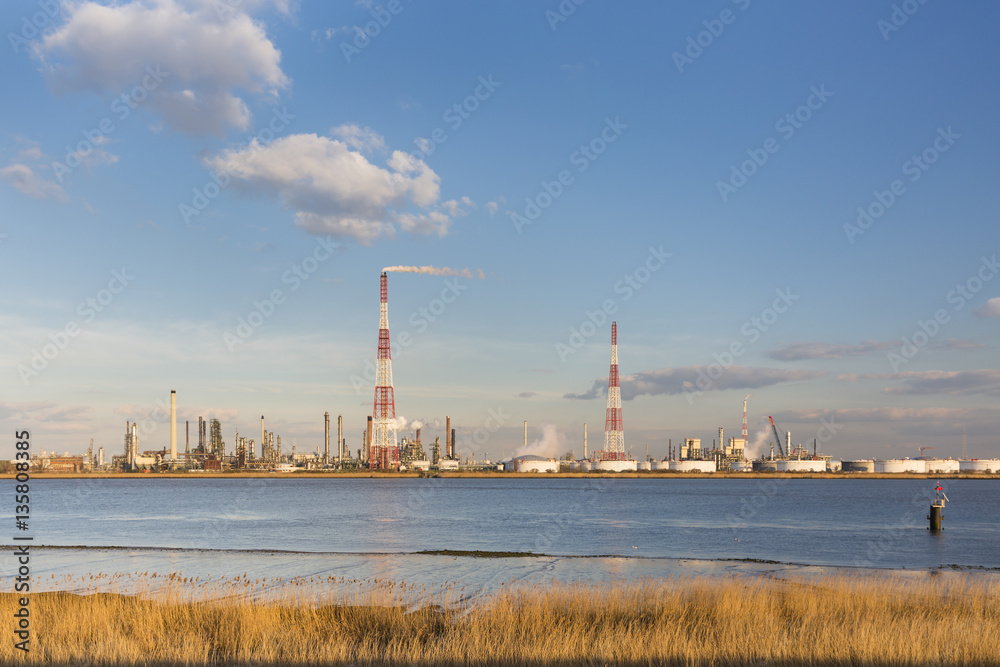 Refinery And River In Evening Sunlight Refinery And River In Evening Sunlight