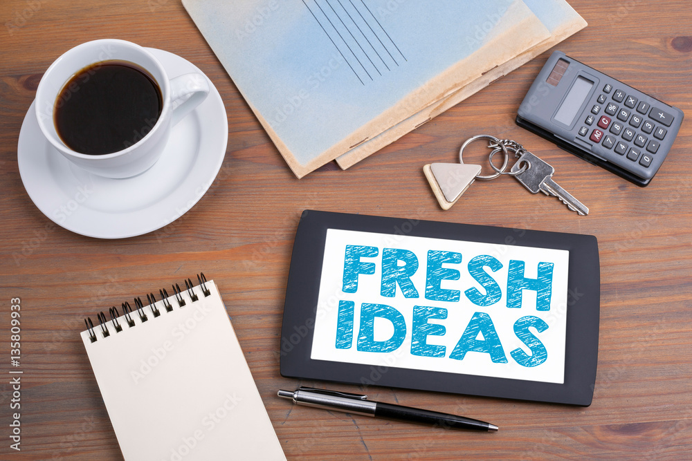 Fresh Ideas, business concept. Text on tablet device on a wooden table. Fresh Ideas, business concept. Text on tablet device on a wooden table.