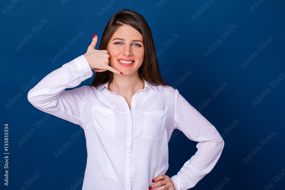 Beautiful woman making a call me gesture Beautiful woman making a call me gesture