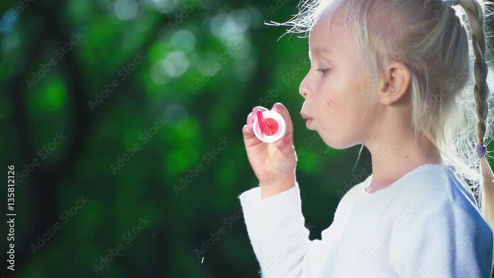 Little girl with a soap bubbles in summer Little girl with a soap bubbles in summer