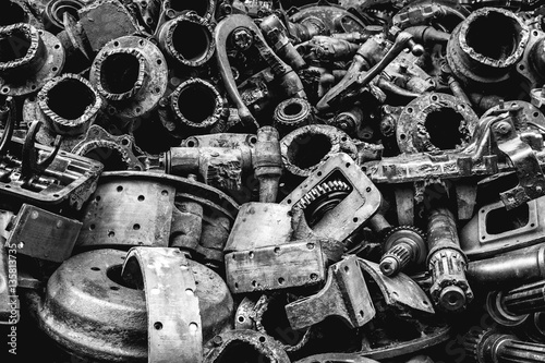 Pile of Used machine parts are oily and rusty in second hand machinery shop, Black and White